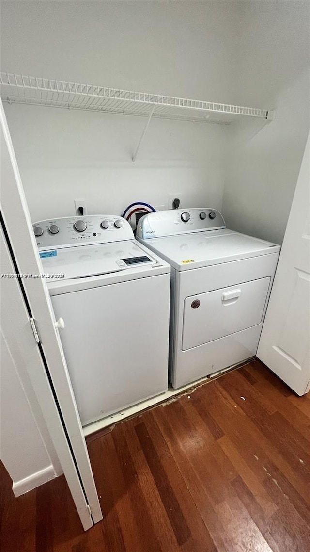 laundry area with washer and clothes dryer and dark hardwood / wood-style flooring