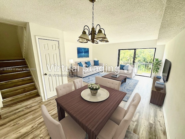 dining area featuring wood-type flooring, a textured ceiling, and a chandelier