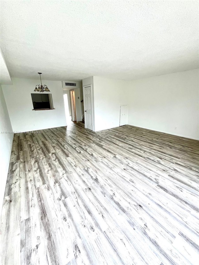 3760 NW 115th Ave Unit 7-4, Coral Springs, FL 33065 - unfurnished living room featuring wood finished floors and a textured ceiling