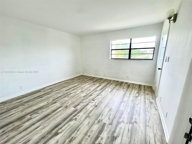 spare room with light wood-type flooring