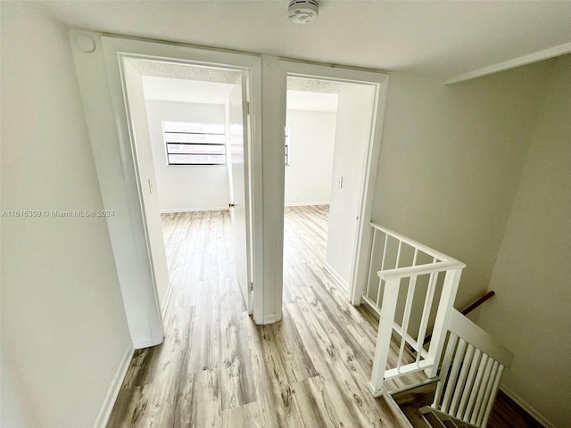 3760 NW 115th Ave Unit 7-4, Coral Springs, FL 33065 - corridor with an upstairs landing, wood finished floors, and baseboards