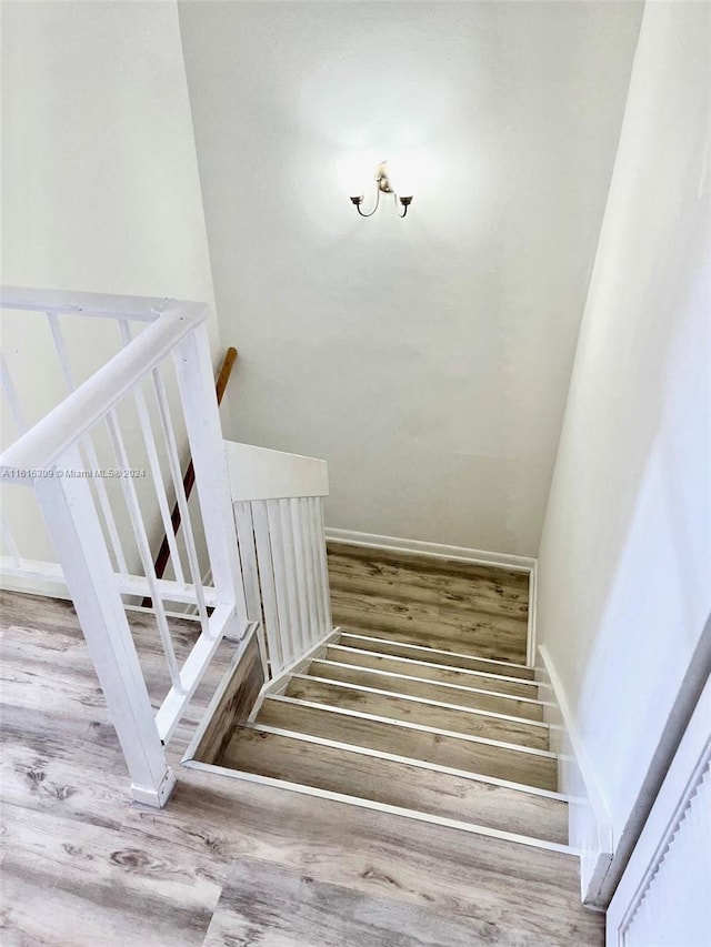 stairs featuring hardwood / wood-style flooring