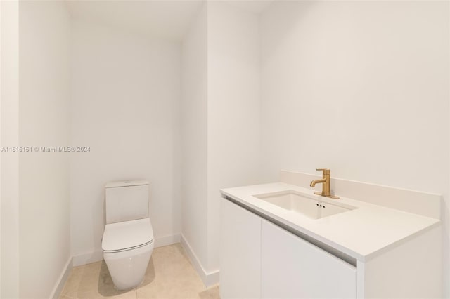 bathroom featuring tile patterned floors, vanity, and toilet