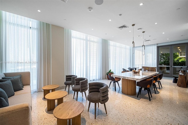 dining room with a wall of windows and plenty of natural light