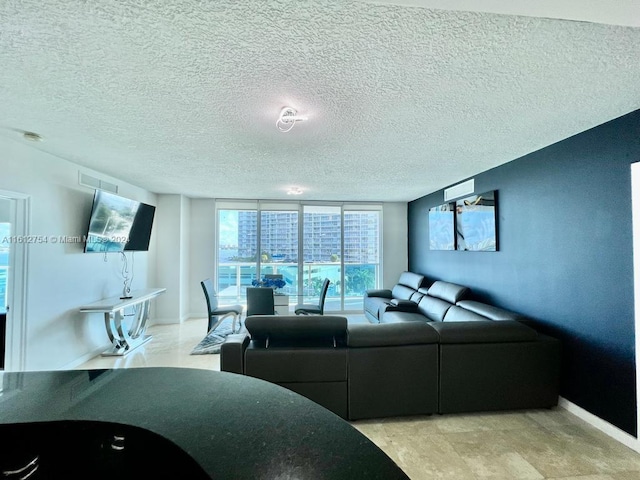 living room featuring a textured ceiling and expansive windows