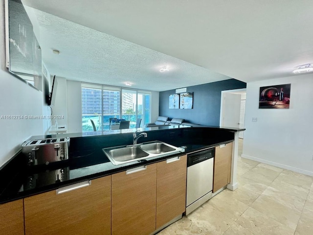 kitchen with dishwasher, a textured ceiling, and sink