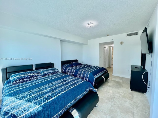 bedroom featuring a textured ceiling