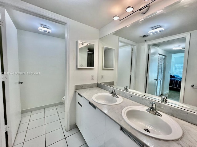 bathroom with tile patterned floors, vanity, and toilet