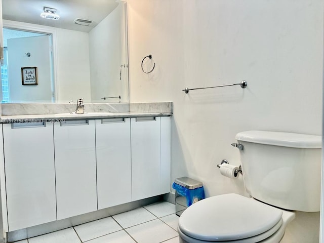 bathroom with tile patterned floors, vanity, and toilet