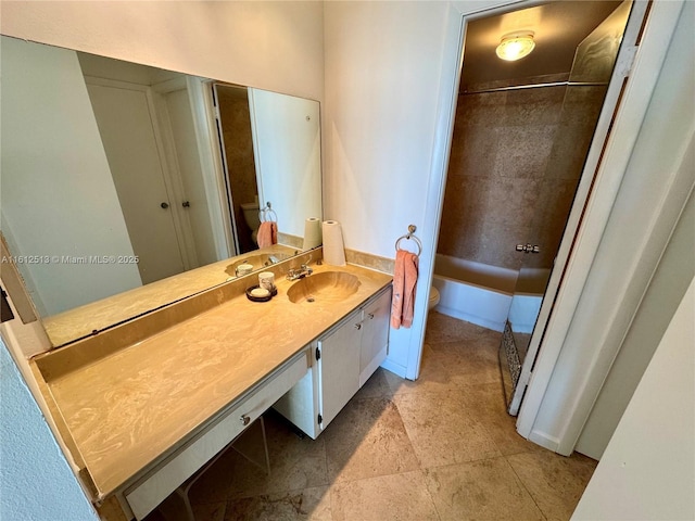 full bathroom featuring vanity, toilet, and tiled shower / bath combo