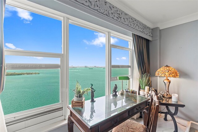 office area with a water view and crown molding