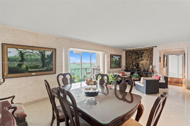 dining space with tile walls and light tile patterned floors