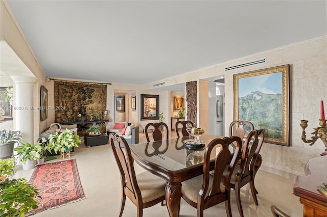 tiled dining area featuring decorative columns