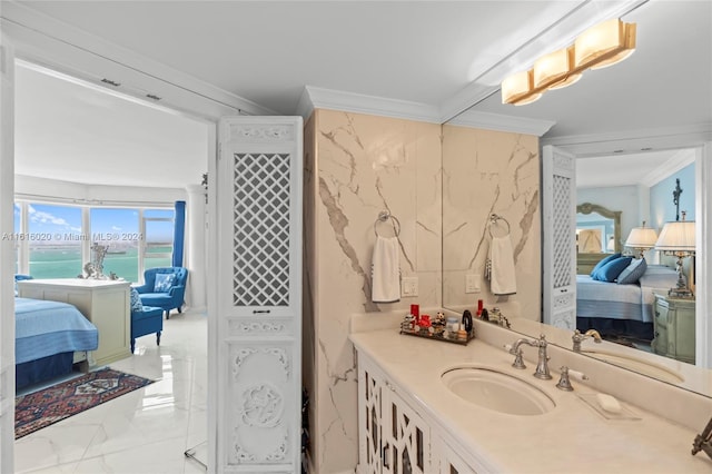 bathroom with ornamental molding, a water view, and vanity