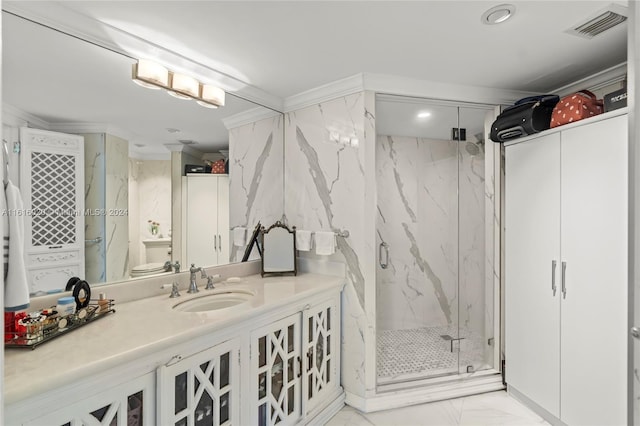 bathroom with ornamental molding, vanity, and a shower with shower door