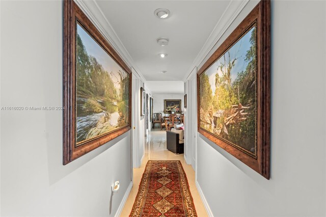 hall featuring light hardwood / wood-style floors and crown molding