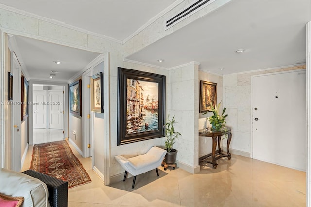 hall with ornamental molding and light tile patterned floors