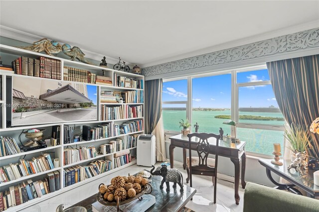 sitting room featuring a water view and ornamental molding