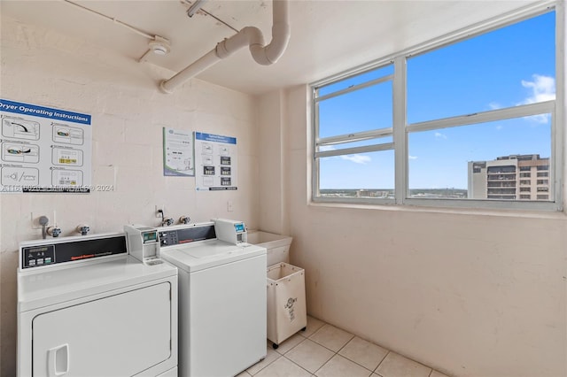 laundry room featuring light tile patterned floors and washer and dryer