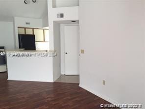 kitchen with dark hardwood / wood-style flooring and refrigerator