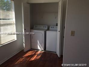 laundry area featuring dark hardwood / wood-style flooring and washing machine and clothes dryer