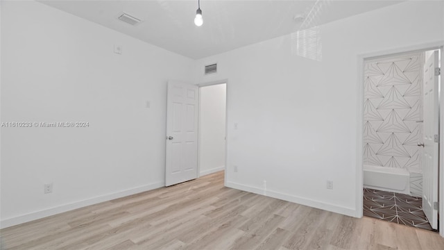 unfurnished bedroom with light wood-type flooring