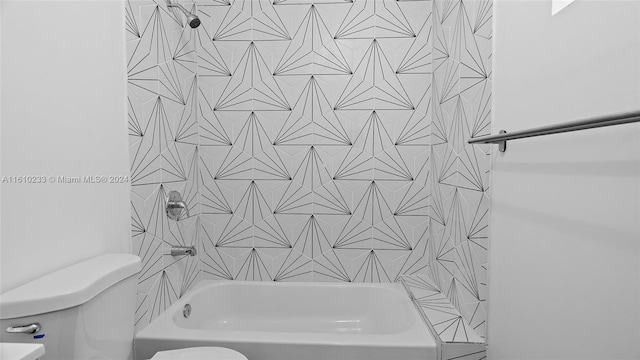 bathroom featuring toilet and tiled shower / bath combo