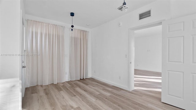 spare room with light wood-type flooring