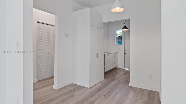 hallway with light hardwood / wood-style flooring