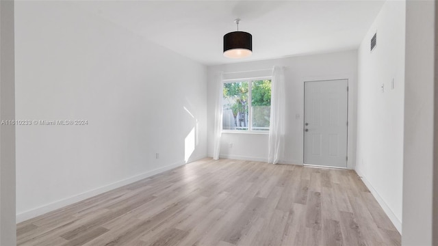 spare room with light hardwood / wood-style flooring