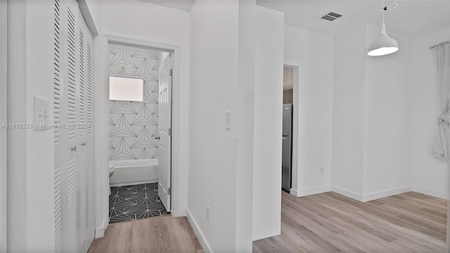 hallway with light wood-type flooring