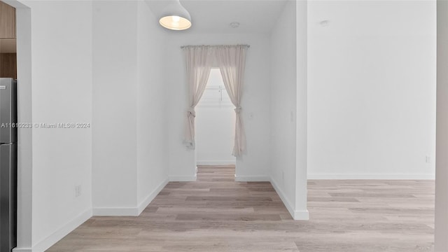 corridor with light wood-type flooring