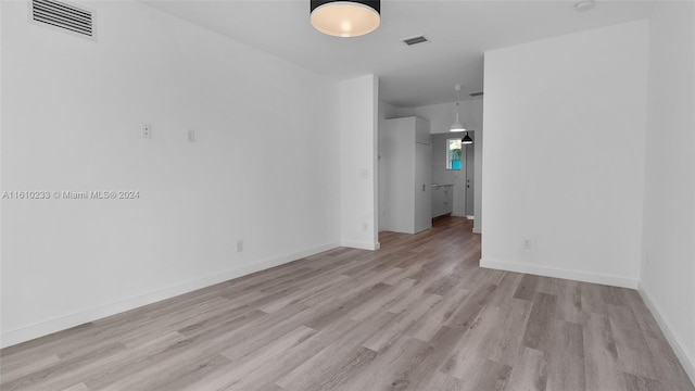 spare room with light hardwood / wood-style floors