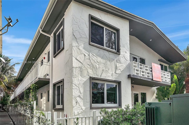 view of side of property featuring a balcony