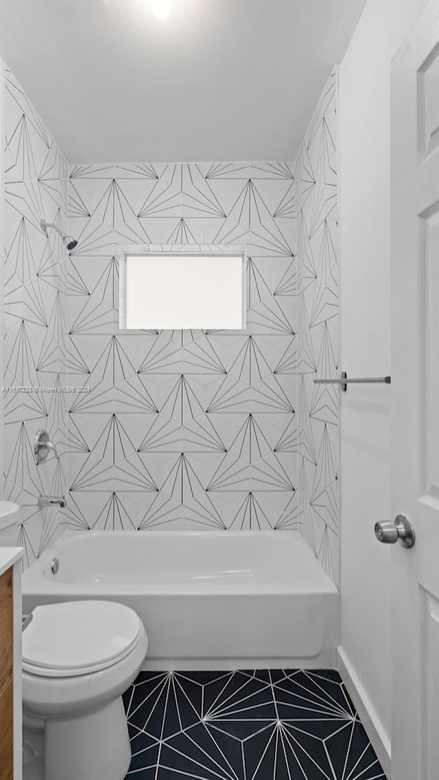 full bathroom featuring toilet, washtub / shower combination, vanity, and tile patterned floors