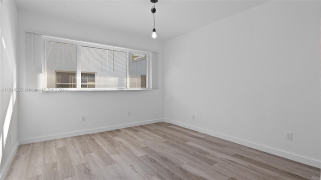 spare room with light wood-type flooring