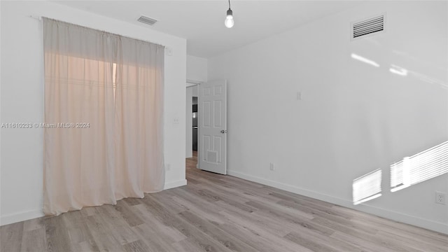 spare room featuring light wood-type flooring