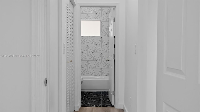 bathroom featuring wood-type flooring and toilet