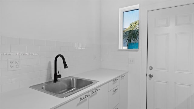 kitchen with white cabinetry and sink