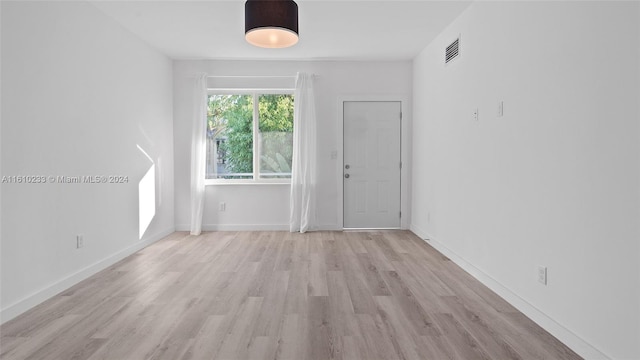 unfurnished room featuring light wood-type flooring