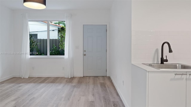 interior space with light hardwood / wood-style flooring and sink