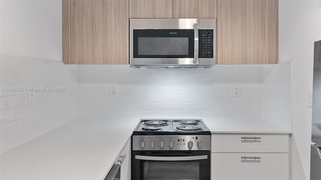 kitchen with decorative backsplash, appliances with stainless steel finishes, and light brown cabinetry