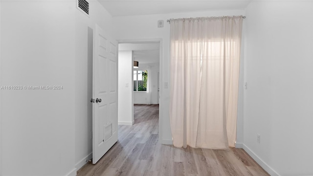 hallway with light hardwood / wood-style flooring