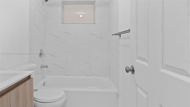 full bathroom featuring toilet, tiled shower / bath combo, and vanity