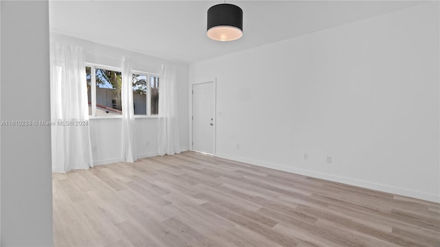 spare room featuring light wood-type flooring