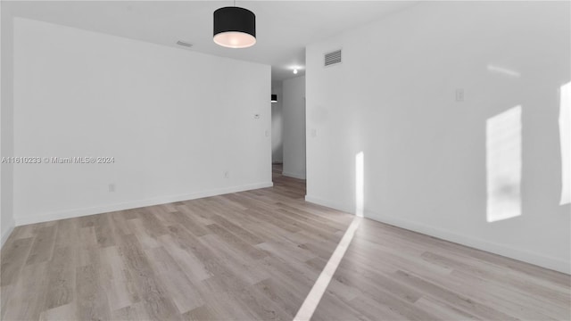 spare room featuring light hardwood / wood-style floors