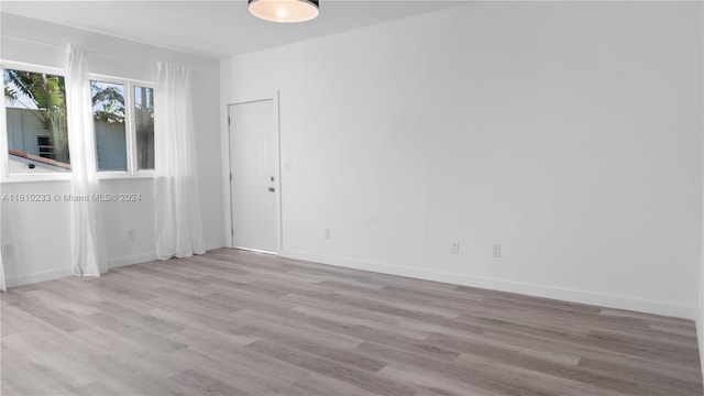 spare room with light hardwood / wood-style flooring