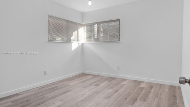 spare room featuring light hardwood / wood-style floors