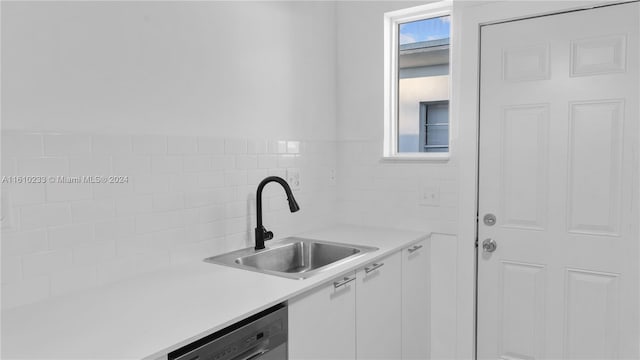 kitchen with white cabinetry, sink, and dishwasher