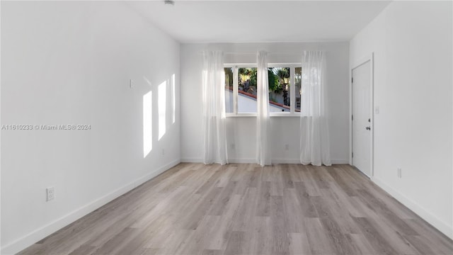 spare room with light wood-type flooring